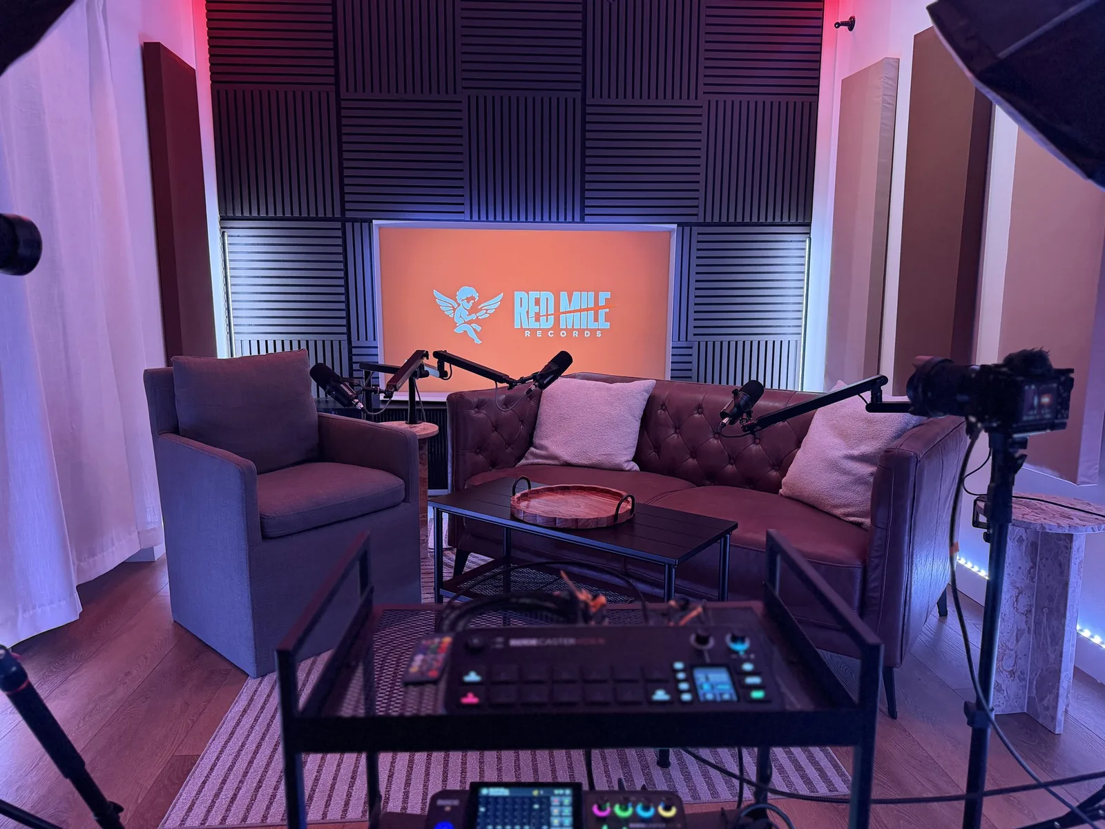 Red Mile Records podcast studio set in Calgary with broadcast microphones, camera and studio lighting