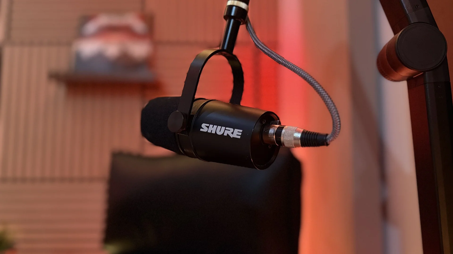 Shure MV7X microphone close-up in acoustically treated podcast studio Calgary